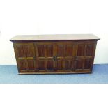 An early 20th century oak Music Cabinet, the rectangular top above four linen fold panelled doors,