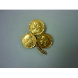 Three gold Half Sovereigns, dated 1898, 1902 and 1912, mounted to form a three-leaf clover brooch.