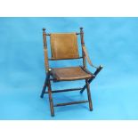 A 20th century mahogany and leather military style folding Armchair, with brass mounts.