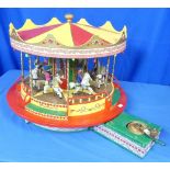 A Painted Wood Mechanical Horse Carousel Toy, with horses and riders, mechanical movement works