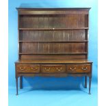 A 19th century oak Dresser and rack, the moulded projecting cornice above three shelves, the base