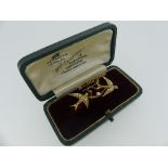 A pretty Bar Brooch, with two swallows in flight set with seed pearls, all mounted in unmarked