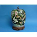A 20th century Chinese black-ground famille rose Pot and Cover, of ovoid form, decorated with