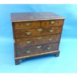 A George II walnut Chest-of-Drawers, the quarter veneered top with cross and feather banding,