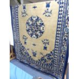 An antique Chinese Peking Carpet, the beige ground with dark blue, light blue, cream and pale pink