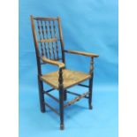 A 19th century ash and elm Lancashire elbow Chair, with turned supports, shaped arms and rush seat.