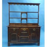 An early 19th century oak Dresser, with an associated open shelved rack, the base with rectangular