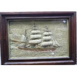 A 19thC Sailor's Woolwork picture of a Sailing Ship, with three-dimensional padded sails appearing