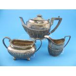 A late Victorian silver near matched three piece Tea Set, by James Dixon & Sons, hallmarked
