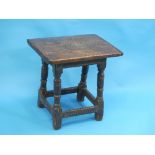 An 18th century oak Joint Stool / low Table, the cleated rectangular top on turned and block