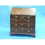 A George III oak Bureau, the rectangular top and hinged fall-front enclosing a fitted interior,