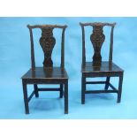 A pair of 19th century ebonised side Chairs, each with a solid seat and carved vase-form splat, on