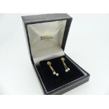 A pair of 9ct yellow gold knot Earrings, with two tassels each with a seed pearl finial, with Boodle