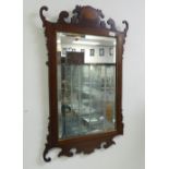 A Georgian-style walnut Mirror, with scrolling crest and shell inlay, the rectangular plate with