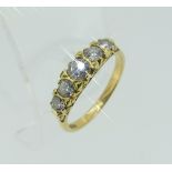 A five stone Diamond Ring, the graduated brilliant cut diamonds set into a scroll gallery and