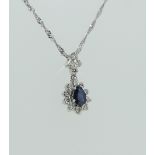 A sapphire and diamond Pendant, the central facetted tear drop shaped sapphire surrounded by ten