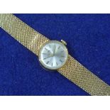 Movado: A lady's gold Cocktail Watch, the circular silvered dial with applied baton markers, on