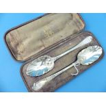 A near matched cased pair of Victorian silver Serving Spoons, hallmarked London, 1853 and 1847,