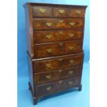 A George II walnut Chest on Chest, the upper part with three short drawers above three long drawers,