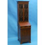 A Victorian mahogany Davenport / Bureau Bookcase, of small size, the moulded cornice above a pair of