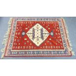 Tribal Rugs; a large mid 20thC Turkish Anatolian Yuruk lambswool carpet, the tomato red ground