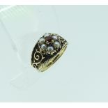 A 9ct yellow gold flared front Ring, with scrolling shoulders, set in the centre with garnet and