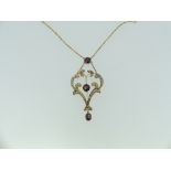 A 9ct yellow gold Art Nouveau style openwork Pendant, set with seed pearls and two circular facetted