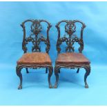 A pair of late-19th century carved mahogany Side Chairs, possibly continental, each with a shaped