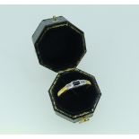 A small calibré cut Sapphire and Diamond Ring, the centre set with calibré cut sapphire and small