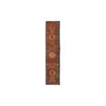 AN ANTIQUE HERIZ RUNNER, NORTH-WEST PERSIA approx: 14ft.3in. x 3ft.(434cm. x 91cm.) The field with