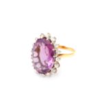 An amethyst and diamond ring, Set with an oval-cut amethyst