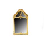 An early 20th century Rococo style gilt wood over mantle mirror