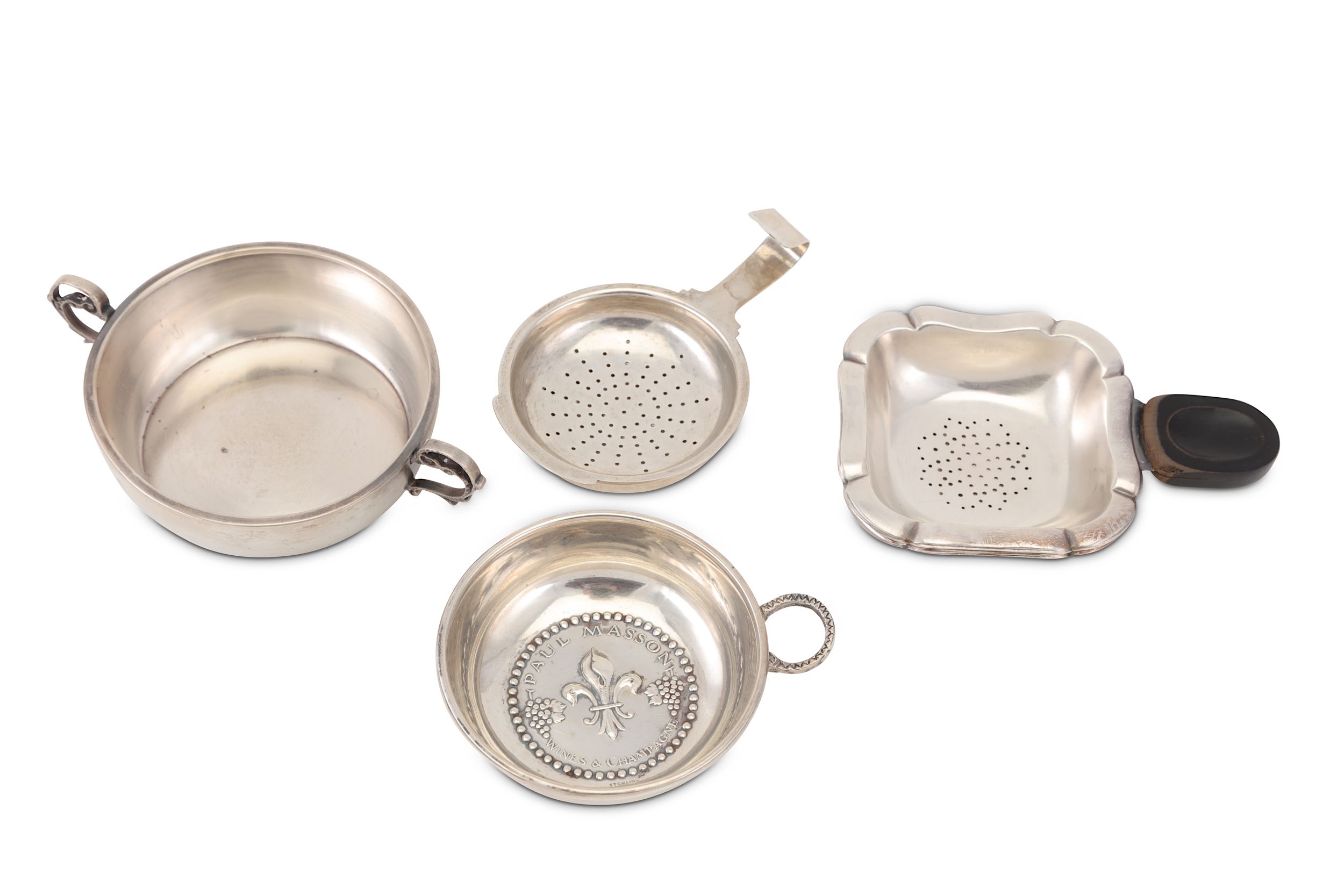 A collection of silver tea strainers, including three English examples