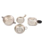 A collection of silver tea strainers, including three English examples