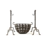 An oval wrought iron fire basket, together with a pair of fire dogs