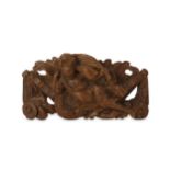 A 17th century carved oak relief depicting a putto