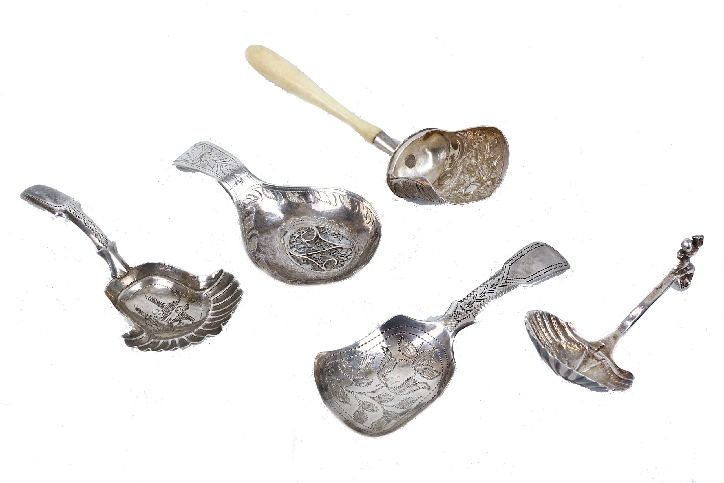 A William IV silver fiddle pattern caddy spoon and others