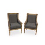 A pair of French Louis XV style giltwood framed wing back chairs