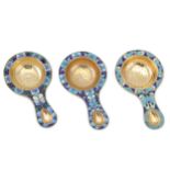 A mixed group of three similar 20th century Russian Soviet Era enamel and silver-gilt tea strainers