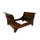 A 19th Century French cherrywood bateau en lit or sleigh bed