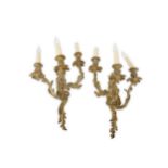 A pair of late 19th or early 20th century French Rococo style gilt metal wall lights