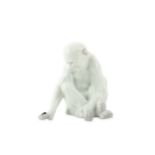 A Heubach Gebruder porcelain figure of a seated monkey