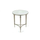 A modern silvered circular side table with mirror top