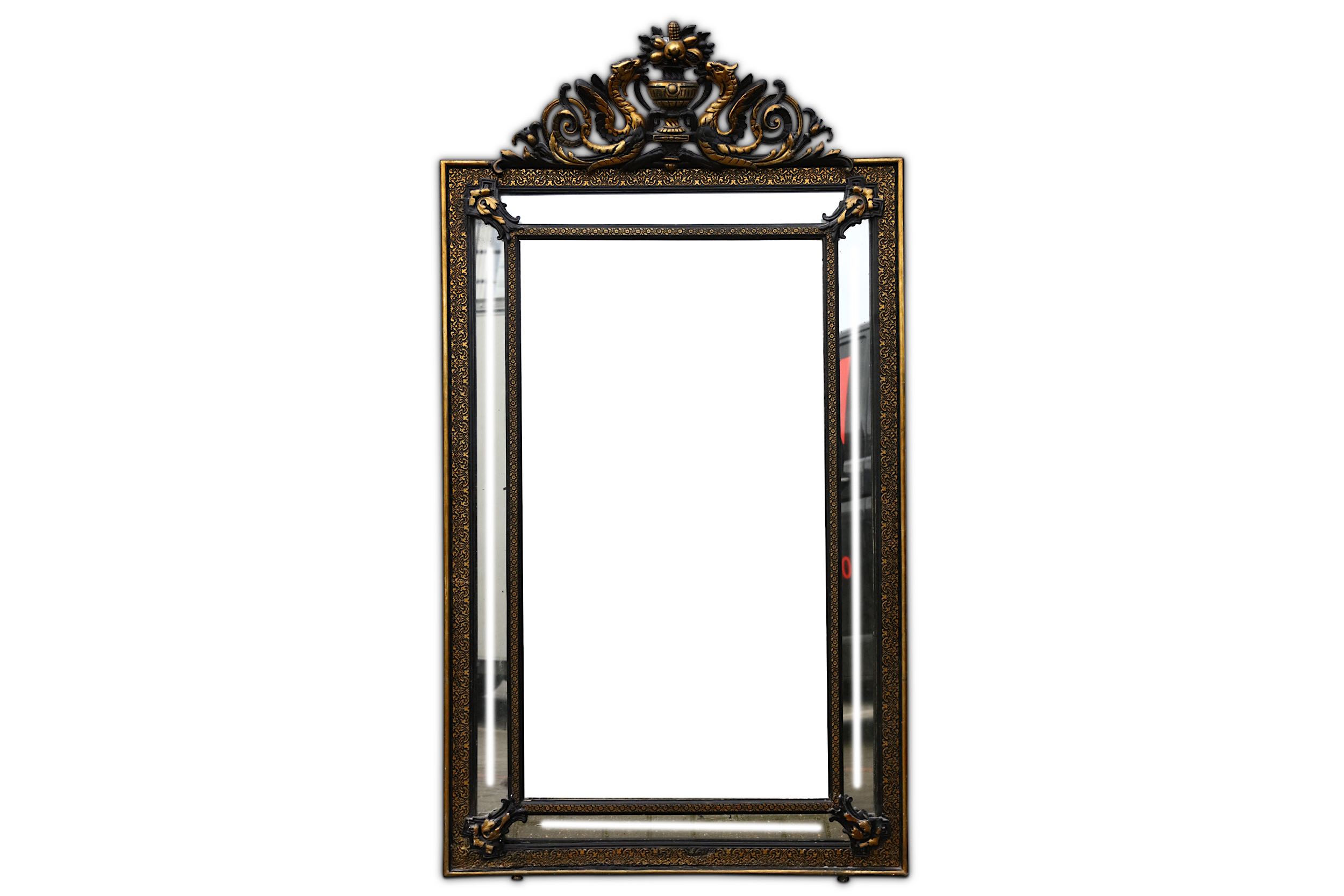 A French 19th century ebonised and parcel gilt cushion framed wall mirror