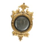 A Regency circular convex mirror with a carved giltwood frame