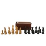 An early 20th Century box wood and stained ebony composite chess set