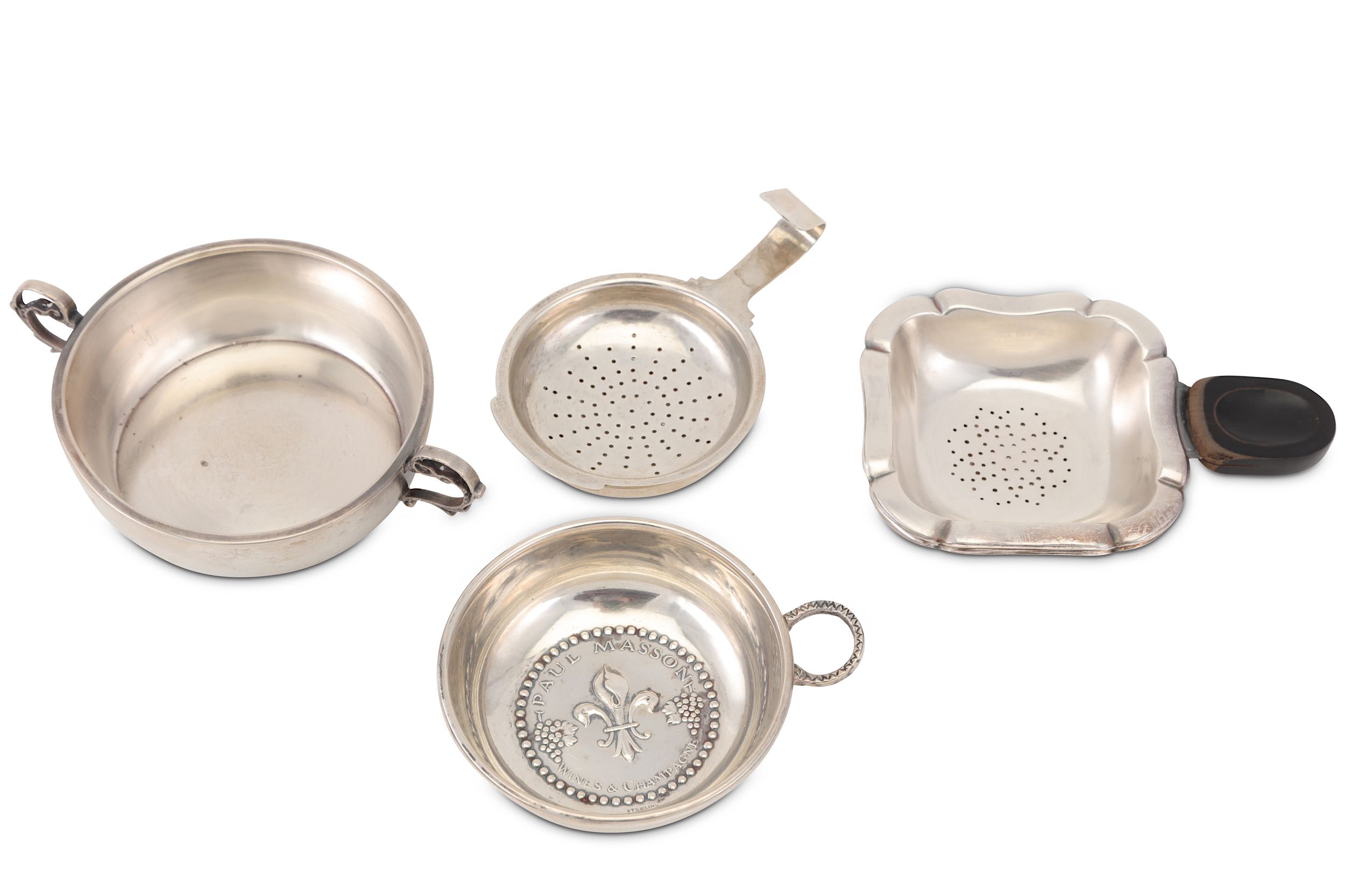 A mixed group of silver tea strainers and wine tasters