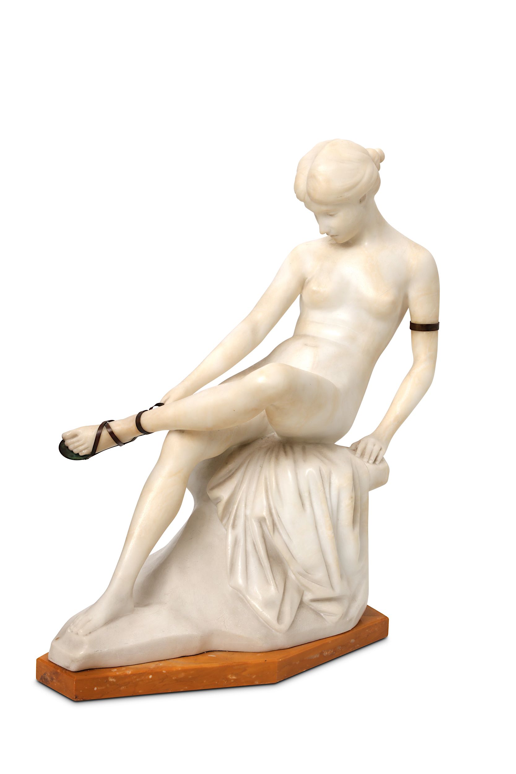 ERNST SEGER, AN ALABASTER AND BRONZE FIGURE OF A SEATED NUDE LACING HER SANDLE.