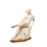 ERNST SEGER, AN ALABASTER AND BRONZE FIGURE OF A SEATED NUDE LACING HER SANDLE.