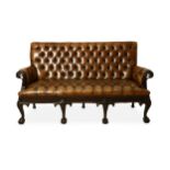 A FINE BROWN LEATHER BUTTON-UPHOLSTERED THREE SEATER SETEE.